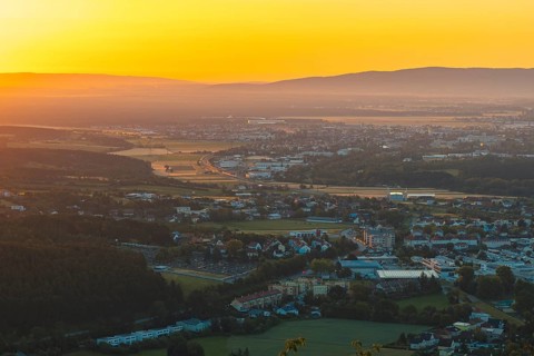 City at sunrise with orange light and surrounding mountains, Ternitz, Lower Austria, Austria