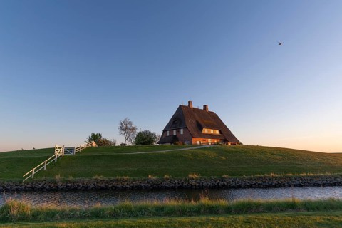 Kirchwarft with pastor and church on Hallig Hooge in the Schleswig-Holstein Wadden Sea National