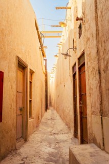 Doha Qatar Katara Cultural Village narrow traditional alley mud brick walls heritage architecture
