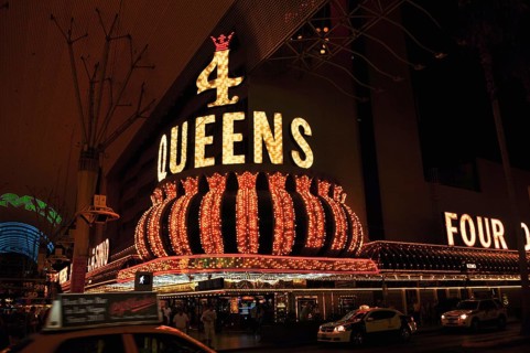 Glowing 4 Queens casino sign at night with majestic-looking crown, Las Vegas, Nevada, USA