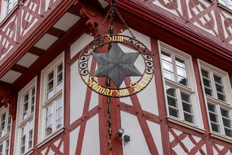 Guild signs and half-timbered houses on the Römerberg in Frankfurt am Main, Hesse, Germany