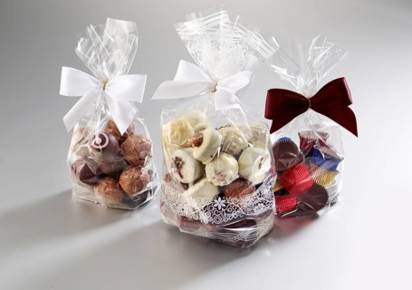 Chocolates packed in transparent bags against a white background, studio shot