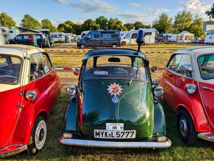 BMW Isetta parking in a row, annual meeting 2026, distinctive dark green small car with front door,