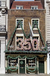 A giant floral 350 marks Lock and Co Hatters' anniversary above its shopfront on St James's Street,