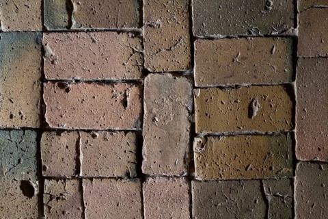 Detailed view, floor with old earth-colored bricks crisscrossed by cracks, church, Husby Church,