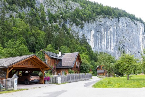 Typical residential building and carport with carvings on the gable, with Gössler Wand in the