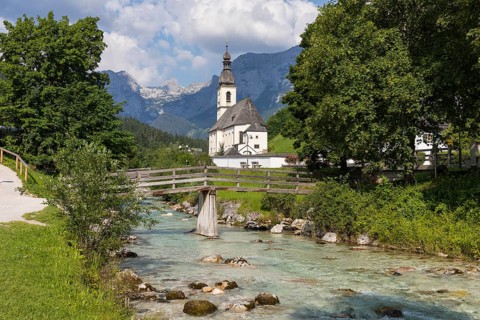 Famous view of the parish church of St. Sebastian with bridge over the Ramsauer Ache in the