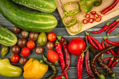 Various vegetables, cucumbers, tomatoes, sliced peppers and chili peppers