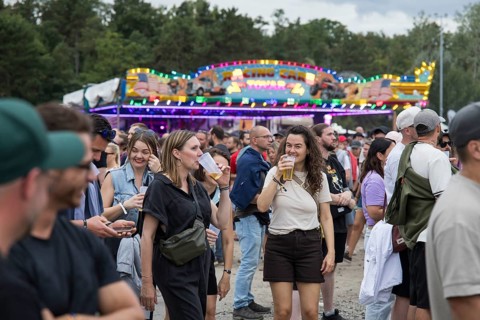 Festival visitors in front of bumper cars at the Klassentreffen Festival on the Central Fairground