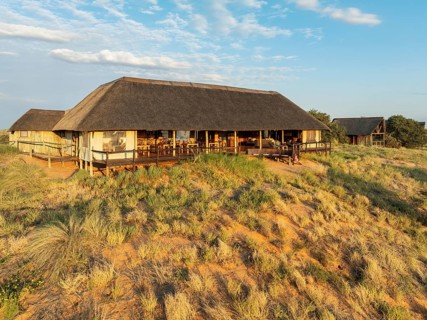 The main building of the Ta Shebube Rooiputs Lodge in the Kalahari Desert during the rainy season