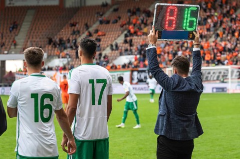 Team manager man shows players substitution during football match in Lubin, Poland