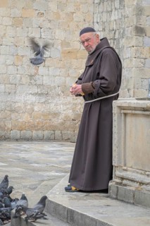 Friar Nedjeljko Jerkan a member of the Franciscan church and monastery, feeds the pigeons at the