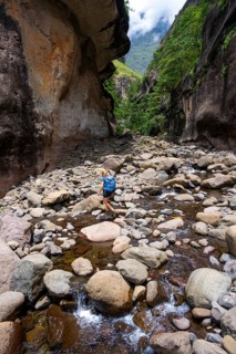 Female hiker in the Tugela Gorge or Tugela Gorge in the riverbed, Drakensberg National Park,