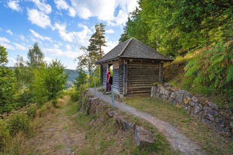 Small hut on hiking trail with green forest and blue sky, Bad Wildbad, Black Forest, Germany