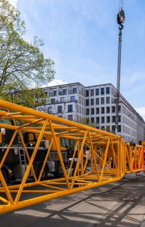 Mobi Hub, heavy construction machine with special technology setting up a crane in the narrow