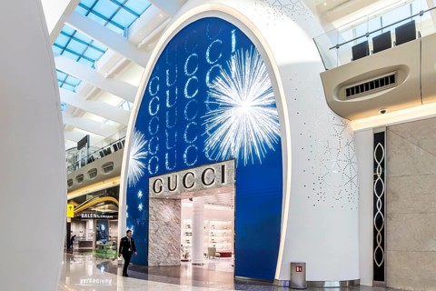 Abu Dhabi Airport, Zayed International Airport with passengers. Duty free shop of the Gucci brand.