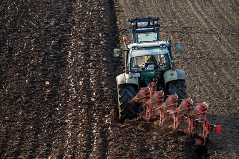 Farmer ploughing a field, tractor with plough, near Neuss, North Rhine-Westphalia, Germany