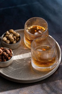 Elegantly presented cognac-based cocktails with cinnamon and star anise, accompanied by bowls of