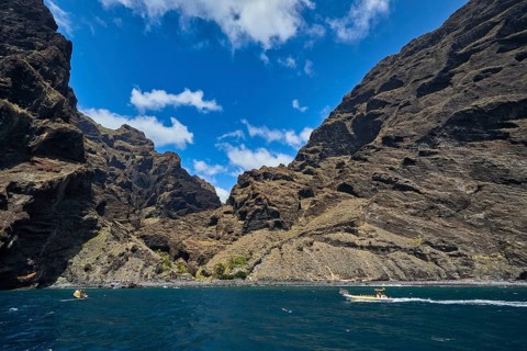 Exit of the Masca gorge, Los Gigantes, impressive rocky gorge with small boats on the sea under a