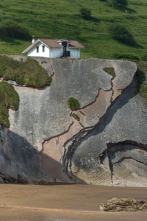 Distinctive rock cliffs as a geological formation of rock layers, Flysch on Itzurun Beach in