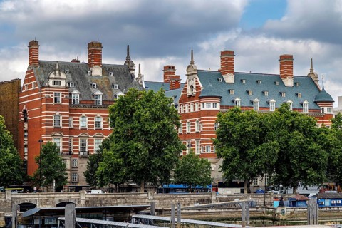 Ornate red brick chimneys and steep gables rise above the former New Scotland Yard building,