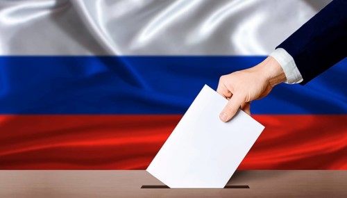 Russia Parliamentary vote 2026. Hand placing a ballot in ballot box with the Russian flag in the
