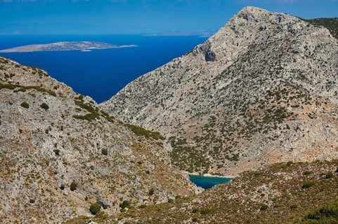 Pezonda Bay, mountainous landscape overlooking the sea under a bright blue sky, Kalymnos, Sponge