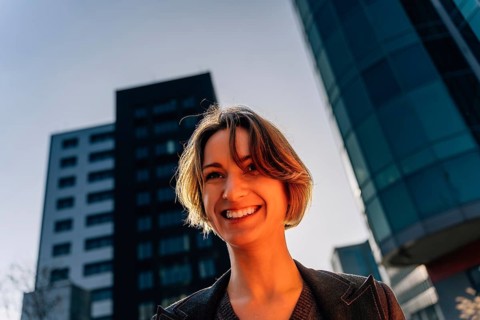 Happy young woman in urban cityscape in business district
