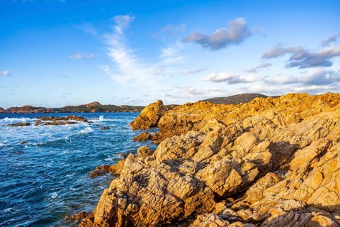 Landscape of the coastline with blue water at Marinedda Coast on a sunny day, Sardinia, Italy