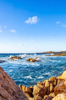 Landscape of the coastline with blue water at Marinedda Coast on a sunny day, Sardinia, Italy