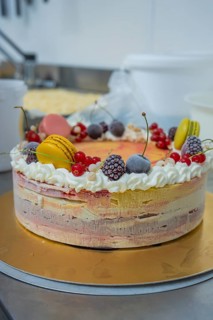 Ice cream cake with cream topping and berries on a golden plate, ice cream cake, Haselstaller Hof,