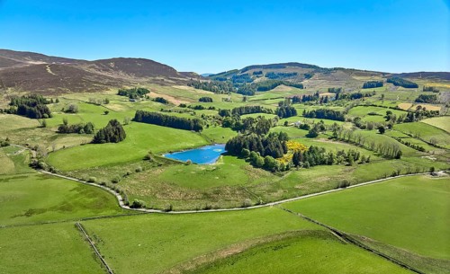 Aerial drone photo of agricultural landscape with meadows and pastures at the border of the Cairn