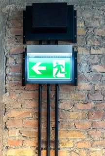 Inotec single-sided LED escape sign light or emergency lighting, wall mounting on brick masonry,