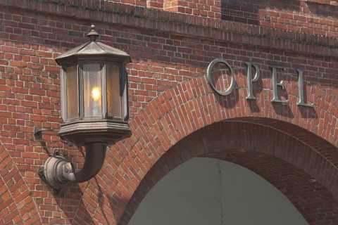 Lantern with light at main portal entrance, Adam Opel AG, inscription, on, burn, brick building,