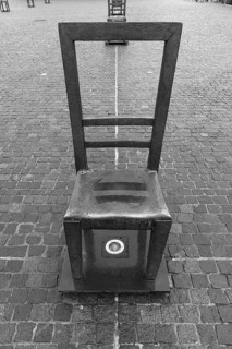 The sixty chairs memorial on the grounds of the Jewish ghetto, black and white, Krakow, Poland