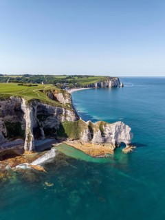 Aerial view of the Falaise d'Amont rock formation with the Porte d'Amont rock gate at low tide, on