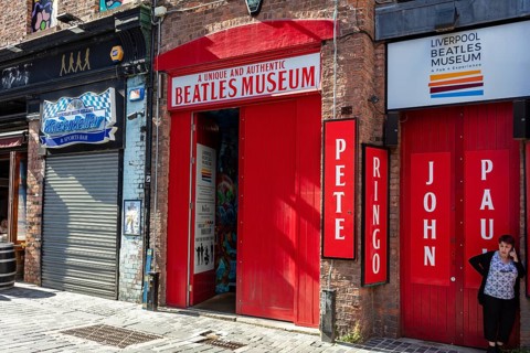 Famous Beatles Museum with distinctive red sign and brick building, Liverpool