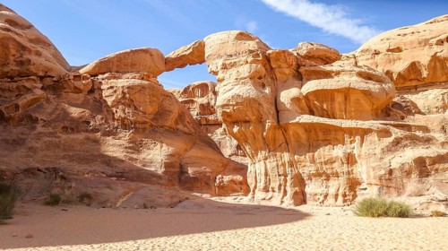 Vivid image capturing the breath-taking natural arches of Wadi Rum in Jordan, showcasing the unique