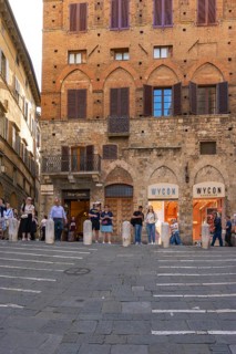 Tourists, sights and restaurants on the famous Piazza del Campo, Siena, Tuscany, Italy