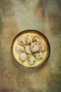 Chicken meatballs, in cream sauce, garnished with parmesan cheese, and microgreens, homemade, no