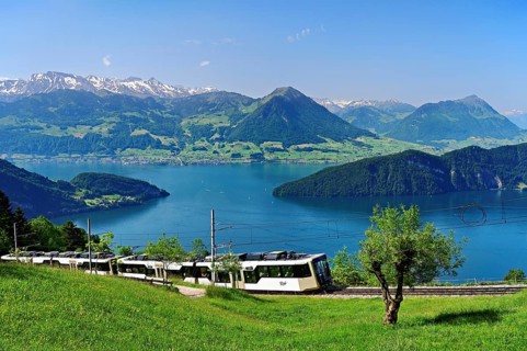 Vitznau Rigi Railway modern grey articulated railcar, behind Lake Lucerne with Buochserhorn,