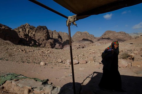 Petra, Jordan. December 11th 2012 A Jordanian Bedouin woman near a monument known as the Pharaohs