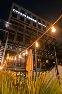 Illuminated restaurant with fairy lights and modern façade at night, Stuttgart, Germany