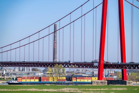Container cargo ship on the Rhine near Emmerich, travelling towards the Netherlands, Rhine bridge,