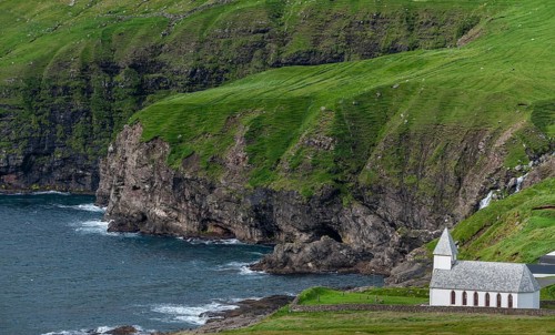 Church on steep rocky coast, surf, Vidareidi, Vidoy Island, Viðareiði, Viðoy Island, Faroe Islands,