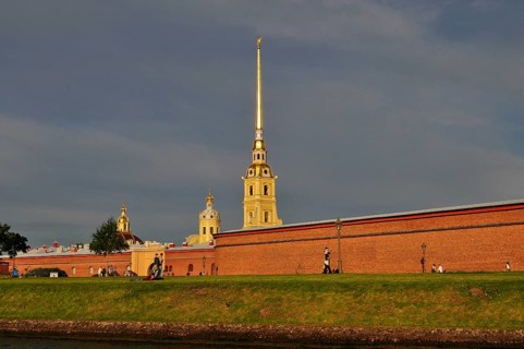 Historic building complex with a tall tower and brick walls under clear skies, Peter and Paul