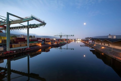 8.5.2026: Container terminal at Stuttgart harbor with cranes and barge under moonlight. Stuttgart,