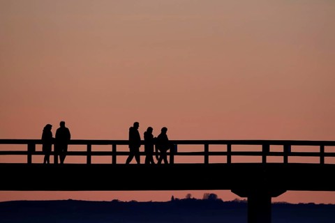 Holidaymakers at sunset on the Sellin pier, Mecklenburg-Western Pomerania, Germany