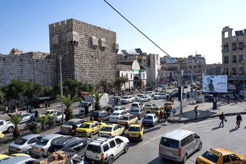 Damascus, Syria. December 7th 2025. Syrian streets busy with traffic in front of the ancient walls