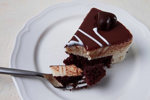 Slice of cake, bird's milk, chocolate sponge cake with souffle, sweet dessert, on a white plate,